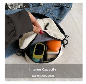 Internal capacity view of mini canvas shoulder bag holding sunglasses and cosmetics
