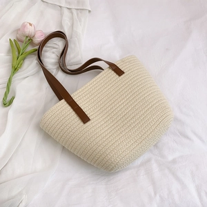 Large straw tote bag with brown leather handles for summer beach and daily commute