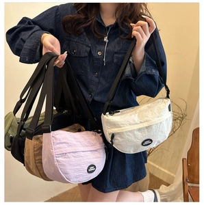 Nylon crescent crossbody bags in multiple colors with adjustable straps and logo detail
