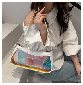 Iridescent transparent underarm bag with white leather trim shown on a model