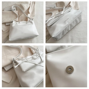 Detail view of cream PU leather shoulder bag featuring gold text and magnetic closure