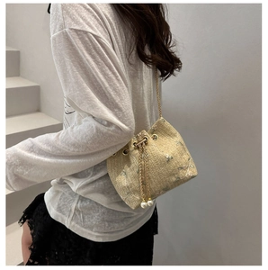 Lace straw bucket bag with floral embroidery and elegant pearl drawstring accents