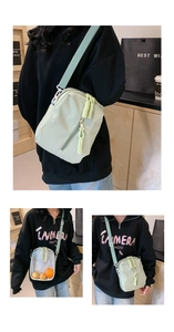 Detail of mint green nylon and transparent PVC crossbody bag with woven zipper pull