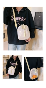 Detail of nylon PVC clear crossbody bag featuring adjustable strap and woven zipper pull