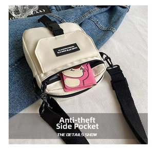 Detail of off-white canvas mini crossbody bag featuring black adjustable strap and buckle