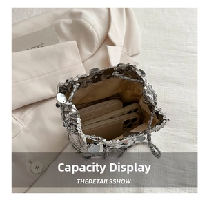 Internal view of silver sequin bucket bag showing capacity for a smartphone and wallet