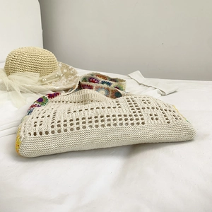 Aesthetic crochet tote bag for women featuring colorful knit flowers and summer beach style