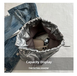 Interior view of silver bucket bag showing large capacity for phone and wallet