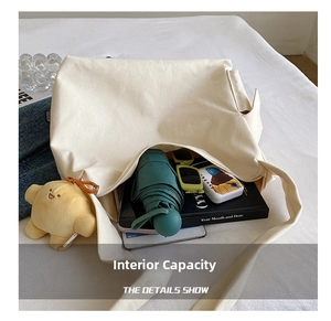Large capacity canvas tote bag showing interior storage for books and accessories