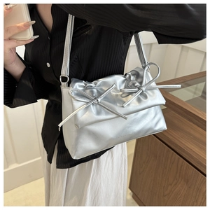 Silver PU leather tote bag featuring a chic pleated top and stylish double bow accents