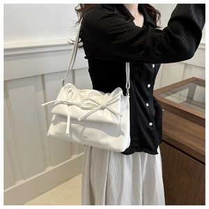 White soft PU leather tote bag with bow detail and Fashion & Bags text on handle