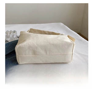 Close-up of the durable wear-resistant bottom on this off-white canvas tote bag