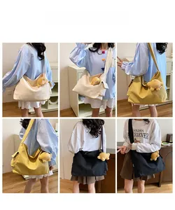 Detail view of large canvas hobo bags in beige, yellow, and black colors for women
