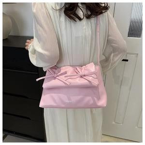 Pink leather crossbody bag featuring stylish bow details and silver FASHION & BAGS logo