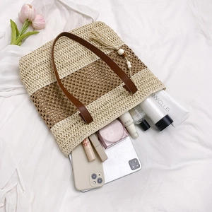 Lazy style straw tote bag with brown leather handles and large interior capacity