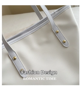 Dettaglio ravvicinato della borsa tote crema con eleganti rivetti dorati lucidi