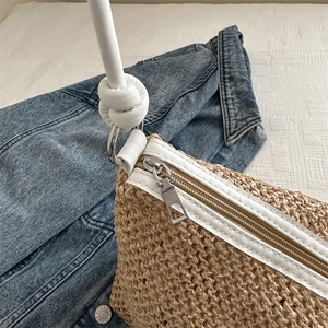 Handmade woven straw tote bag with white leather straps and silver zipper details