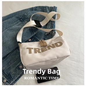 Detail of white nylon crossbody bag with TREND letter patch and phone size comparison