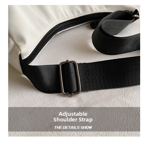 Close-up of adjustable black fabric strap and metal buckle on white minimalist tote bag