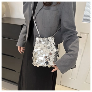 Detailed close-up of a mini silver sequin bucket bag with a stylish metal chain strap