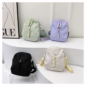 Minimalist nylon crossbody bags in mint, purple, black, and beige colors on a white background