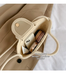 Macro shot of large capacity woven tote bag interior with magnetic closure and items