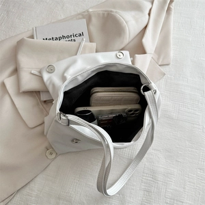 White soft PU leather tote bag with flap and silver magnetic buckles on blazer