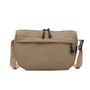 Minimalist khaki crescent crossbody bag with multiple pockets and adjustable nylon strap