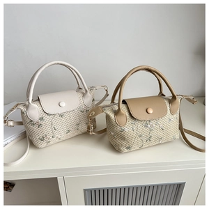 Detail shot of elegant floral embroidery and woven texture on stylish beige handbags