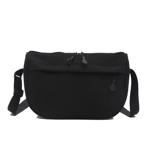 Minimalist black nylon crossbody bag with dual-zipper compartments and adjustable wide strap