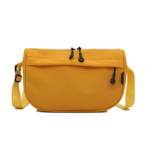 Lightweight bright yellow nylon crossbody bag for women with adjustable strap and zip closure