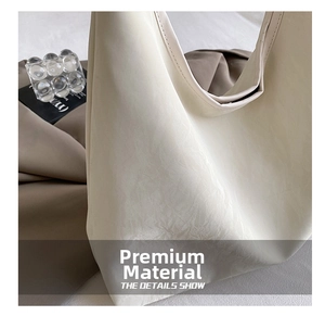 Detail view of cream PU leather handbag with cracked marble texture and luxury finish