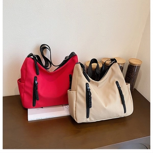 Detailed shot of tote bags featuring vertical front zippers and large capacity side pockets