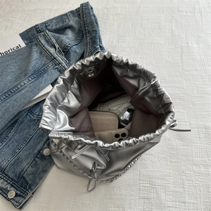 Silver metallic drawstring bucket bag with chain strap and large capacity interior