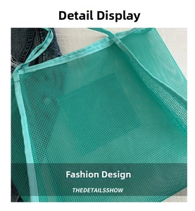 Close-up of mint green mesh tote bag showing honeycomb texture and durable fabric trim
