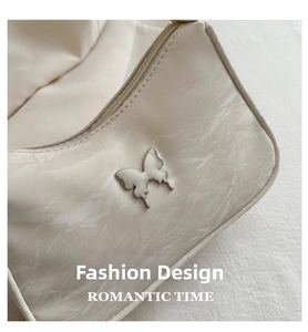 Close-up of marble texture shoulder bag featuring a silver butterfly metallic buckle