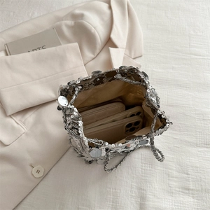 Chic silver sequin bucket bag with chain strap and spacious interior for daily essentials