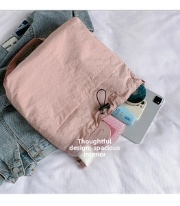 Detailed view of pink drawstring bucket bag showing large capacity with daily essentials