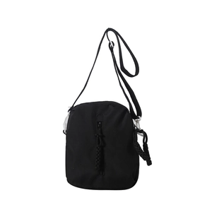Minimalist black nylon crossbody bag with white plastic buckles and woven zipper pullers