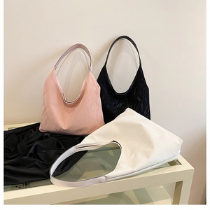 Three large tote bags in pink, black, and white with textured PU leather finish