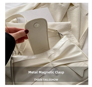 Close-up of white leather bow bag featuring a secure metal magnetic buckle closure
