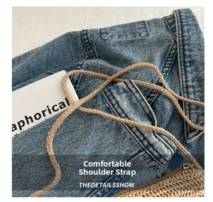 Close-up of a woven straw bag featuring a comfortable three-strand braided shoulder strap