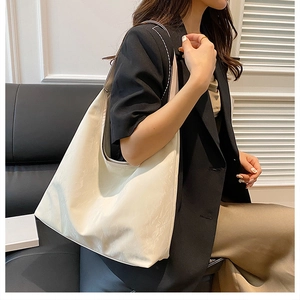 Close-up of cream-colored large capacity tote bag with natural textured faux leather