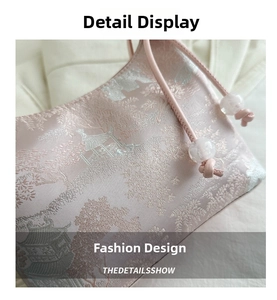 Detail of pink satin drawstring bag featuring intricate Chinese jacquard architecture patterns