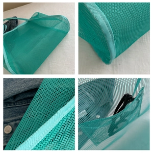 Detail view of mint green mesh tote bag with internal pocket and reinforced stitching