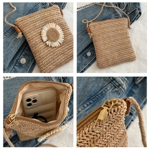 Detailed views of beige straw woven crossbody bag with white daisy decor and interior lining