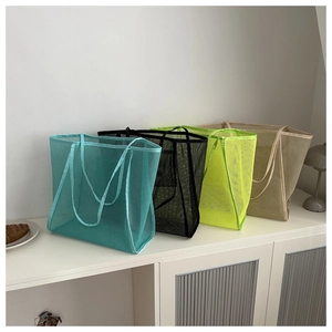 Detailed row of four transparent mesh tote bags in blue, black, yellow and khaki colors