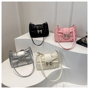 Macro shot of stylish bow-knot handbags in black pink silver and beige colors