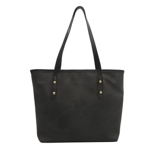 Minimalist black tote bag with matte finish and gold rivet details for daily commute