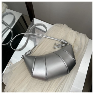 Detail of silver croissant bag with quilted pleats and knotted leather shoulder strap